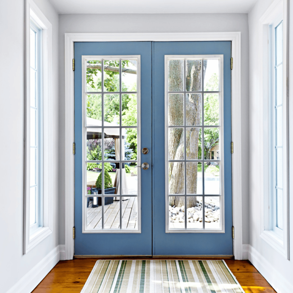 blue french hinged doors in a home that lead to the outdoor deck and patio area
