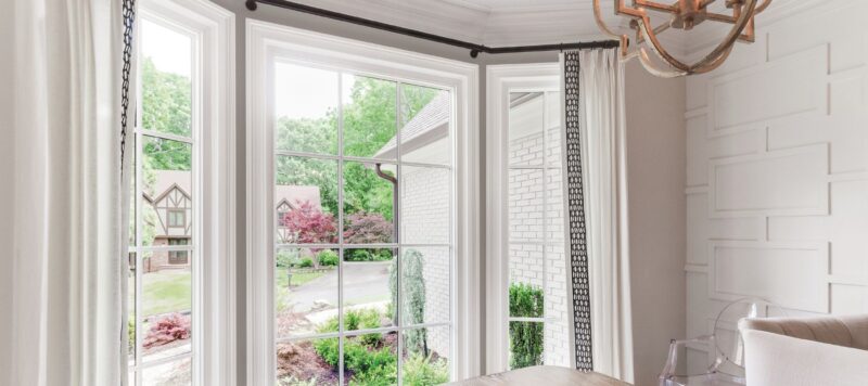 a dining room window looking out into a neighborhood