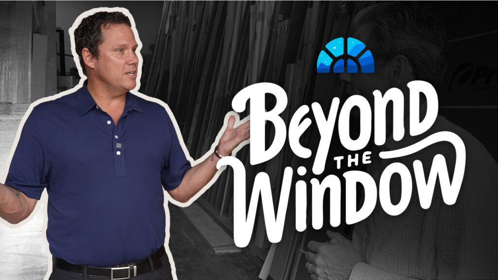 A smiling man holding an apple points to a “Beyond the Window” logo over a market scene