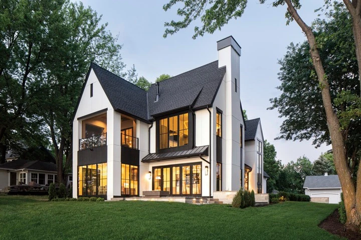 Contemporary multi-story home with black-trimmed windows and sharp architectural lines