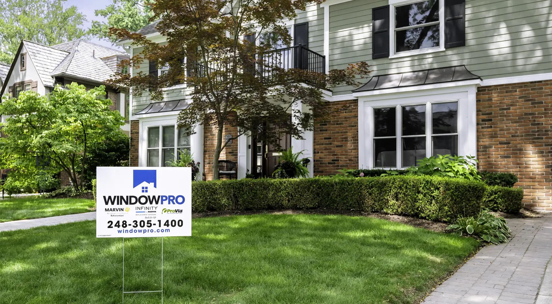 House with landscaping and sign